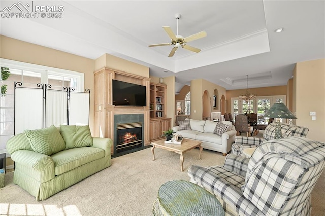 3479 Hill Cir, Colorado Springs, CO 80904 - living area featuring a raised ceiling, a chandelier, arched walkways, carpet flooring, and a fireplace