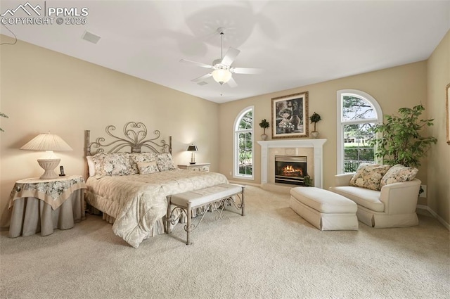 3479 Hill Cir, Colorado Springs, CO 80904 - bedroom with multiple windows, carpet, a glass covered fireplace, and ceiling fan