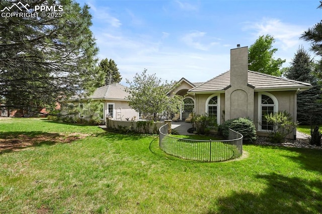 3479 Hill Cir, Colorado Springs, CO 80904 - back of house with a chimney and stucco siding