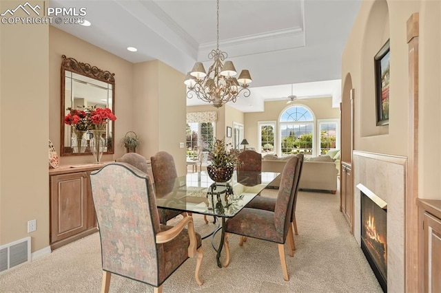 3479 Hill Cir, Colorado Springs, CO 80904 - dining room with light carpet, a raised ceiling, crown molding, a chandelier, and a fireplace