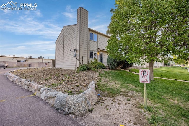 1810 Lanka Ln, Colorado Springs, CO 80915 - view of property exterior featuring a chimney and a lawn