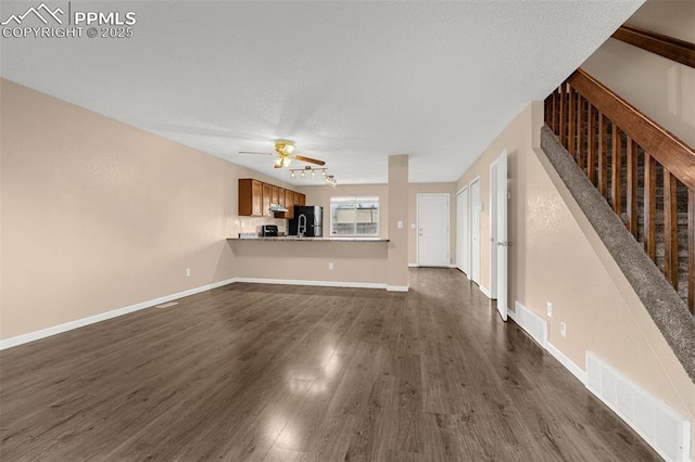 1810 Lanka Ln, Colorado Springs, CO 80915 - unfurnished living room featuring a ceiling fan, dark wood-style floors, stairs, and baseboards