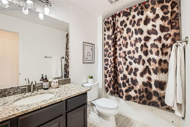 1747 Satin Spar Pt, Colorado Springs, CO 80908 - bathroom featuring vanity, toilet, shower / bath combination with curtain, and wood finished floors