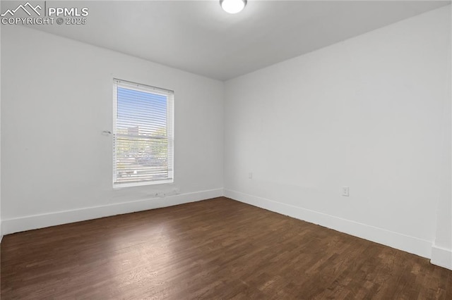 322 Broadway Ave, Pueblo, CO 81004 - spare room featuring baseboards and dark wood-style flooring