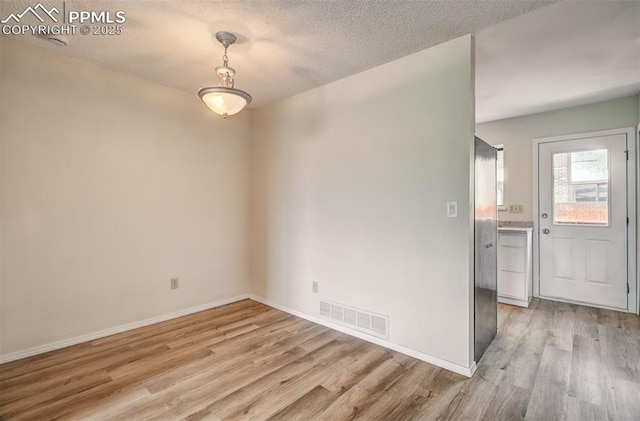 5573 Tamworth Dr, Colorado Springs, CO 80919 - empty room with light wood finished floors, a textured ceiling, and baseboards