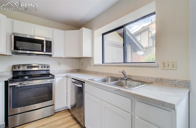 5573 Tamworth Dr, Colorado Springs, CO 80919 - kitchen with stainless steel appliances, a sink, healthy amount of natural light, and white cabinetry