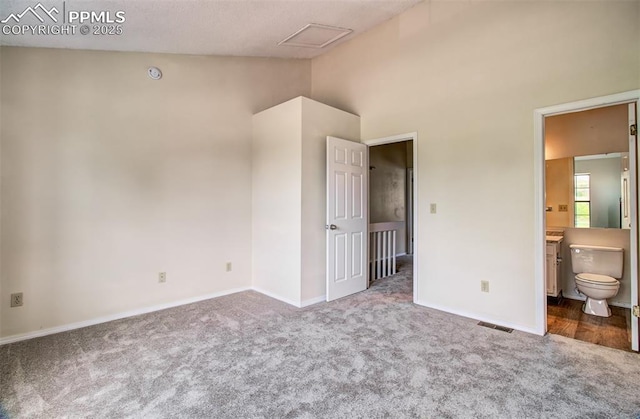5573 Tamworth Dr, Colorado Springs, CO 80919 - unfurnished bedroom with carpet floors, baseboards, vaulted ceiling, and ensuite bath