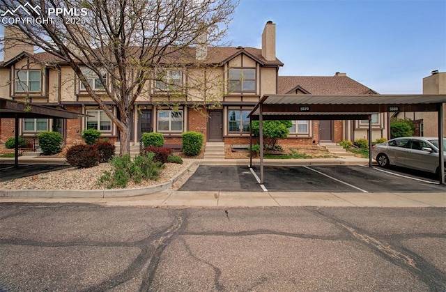 5573 Tamworth Dr, Colorado Springs, CO 80919 - view of front of property featuring brick siding, covered parking, and a chimney