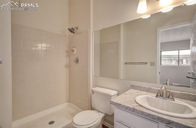 5573 Tamworth Dr, Colorado Springs, CO 80919 - full bathroom with vanity, toilet, and tiled shower
