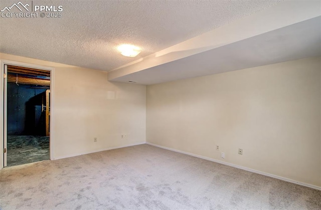 5573 Tamworth Dr, Colorado Springs, CO 80919 - unfurnished bedroom featuring carpet floors, a textured ceiling, baseboards, and a walk in closet