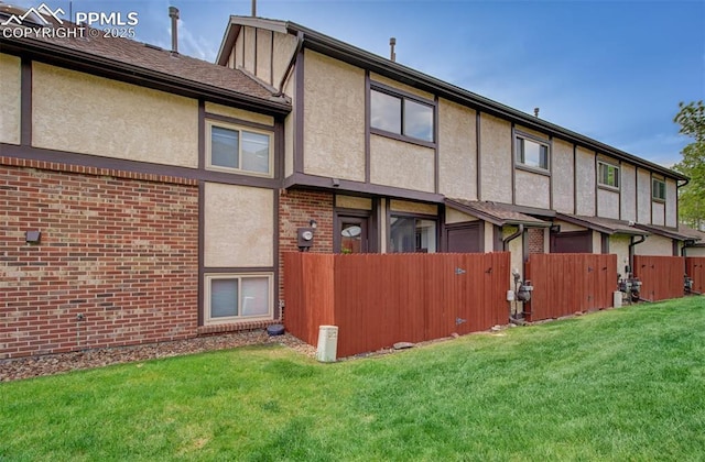 5573 Tamworth Dr, Colorado Springs, CO 80919 - back of house featuring stucco siding and brick siding