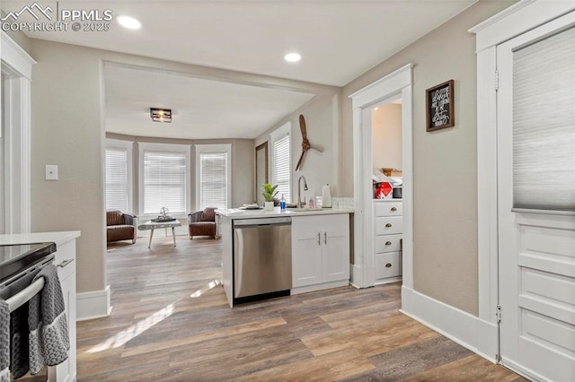 1807 W Colorado Ave, Colorado Springs, CO 80904 - kitchen with stainless steel appliances, wood finished floors, open floor plan, a sink, and light countertops