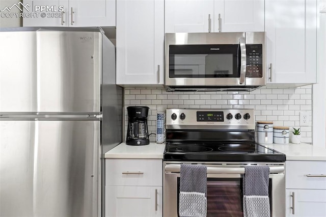 1807 W Colorado Ave, Colorado Springs, CO 80904 - kitchen with stainless steel appliances, white cabinetry, light countertops, and decorative backsplash
