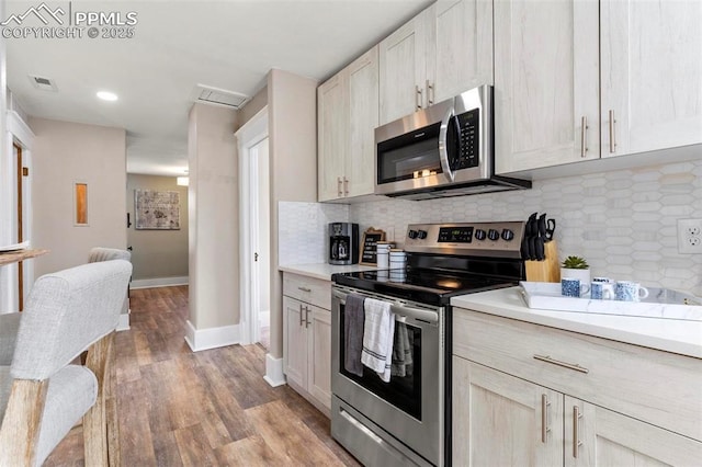 1807 W Colorado Ave, Colorado Springs, CO 80904 - kitchen featuring appliances with stainless steel finishes, light wood finished floors, light countertops, decorative backsplash, and recessed lighting