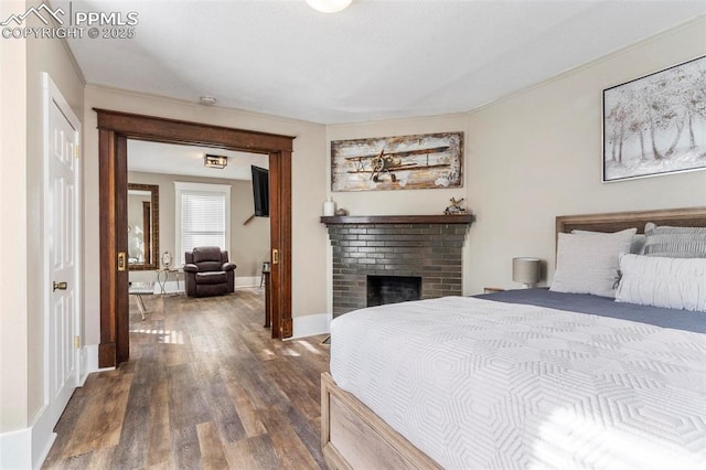 1807 W Colorado Ave, Colorado Springs, CO 80904 - bedroom featuring dark wood finished floors, ornamental molding, baseboards, and a fireplace