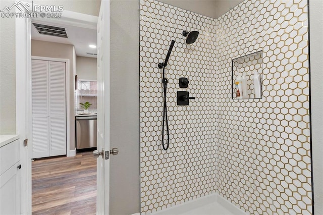 1807 W Colorado Ave, Colorado Springs, CO 80904 - bathroom featuring tiled shower, wood finished floors, and vanity