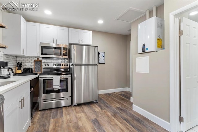 1807 W Colorado Ave, Colorado Springs, CO 80904 - kitchen with stainless steel appliances, white cabinetry, baseboards, decorative backsplash, and recessed lighting