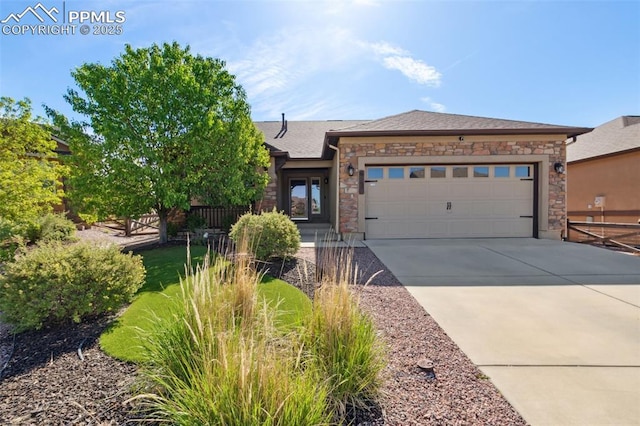 6535 Forest Thorn Ct, Colorado Springs, CO 80927 - view of front of home with stone siding, concrete driveway, and an attached garage