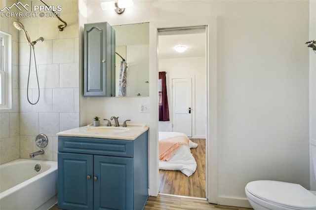 133 W Golden Ave, Cripple Creek, CO 80813 - bathroom featuring vanity, toilet, shower / tub combo with curtain, and wood finished floors
