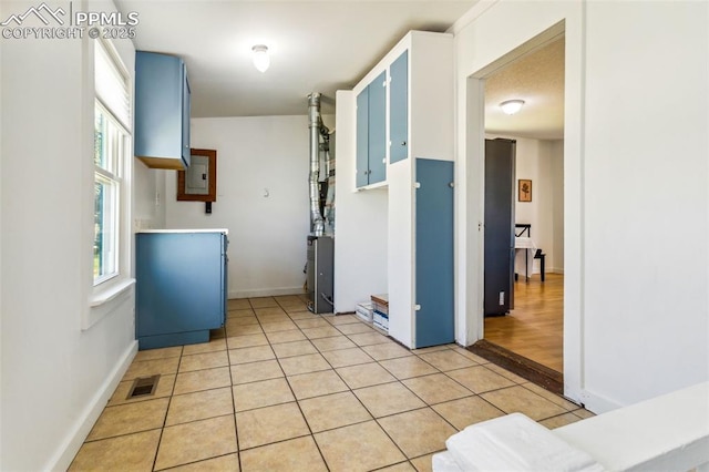 133 W Golden Ave, Cripple Creek, CO 80813 - kitchen with light tile patterned floors, baseboards, and electric panel