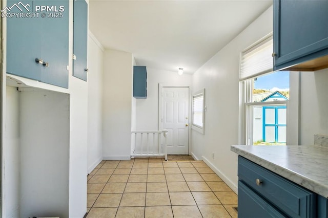 133 W Golden Ave, Cripple Creek, CO 80813 - unfurnished dining area featuring light tile patterned floors and baseboards