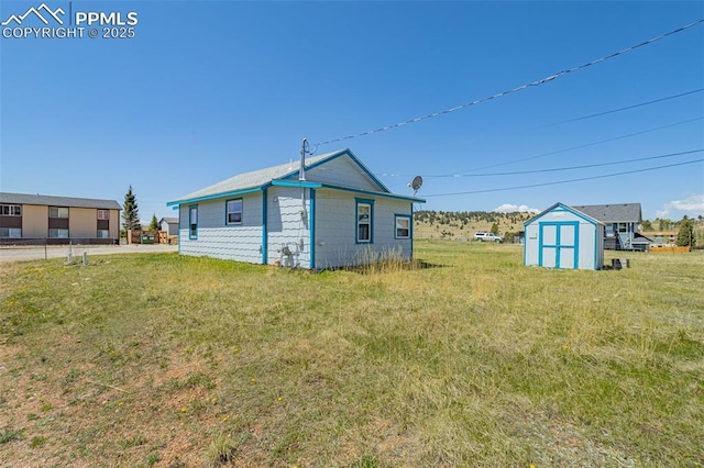 133 W Golden Ave, Cripple Creek, CO 80813 - rear view of house with a lawn