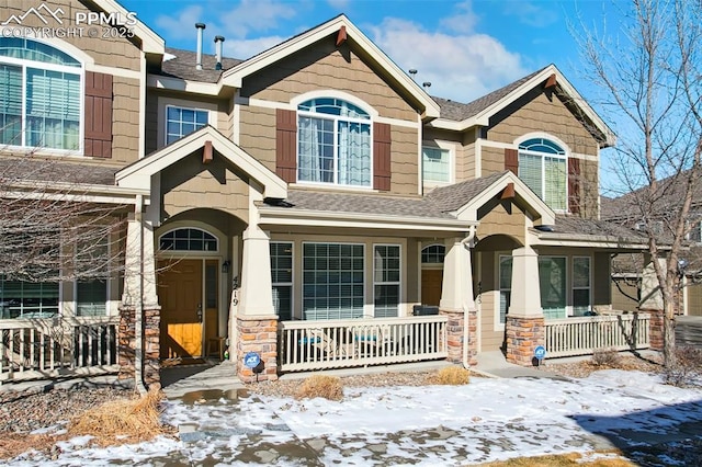 4219 Mesa Point, Colorado Springs, CO 80923 - craftsman-style house featuring covered porch, stone siding, and a shingled roof