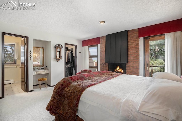 2518 Avondale Dr, Colorado Springs, CO 80917 - bedroom featuring baseboard heating, a textured ceiling, multiple windows, light carpet, and a walk in closet