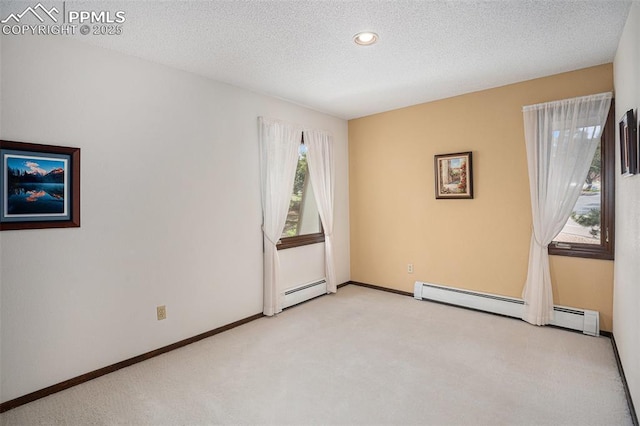 2518 Avondale Dr, Colorado Springs, CO 80917 - carpeted spare room with a baseboard radiator, a textured ceiling, recessed lighting, and baseboards
