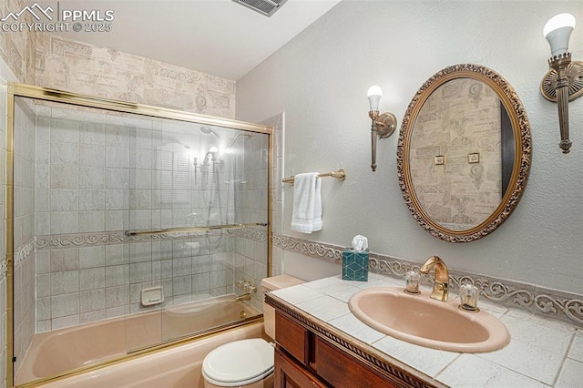 2518 Avondale Dr, Colorado Springs, CO 80917 - full bathroom featuring vanity, toilet, and combined bath / shower with glass door