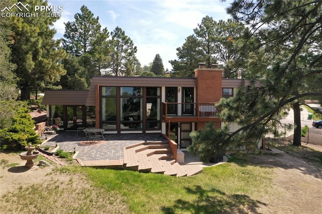 2518 Avondale Dr, Colorado Springs, CO 80917 - rear view of house featuring a wooden deck and a chimney