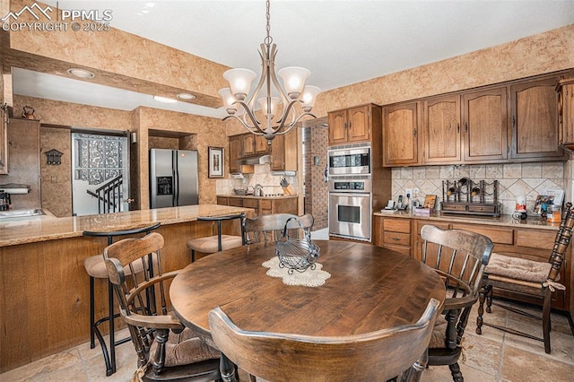 2518 Avondale Dr, Colorado Springs, CO 80917 - dining space featuring stone tile floors and a chandelier