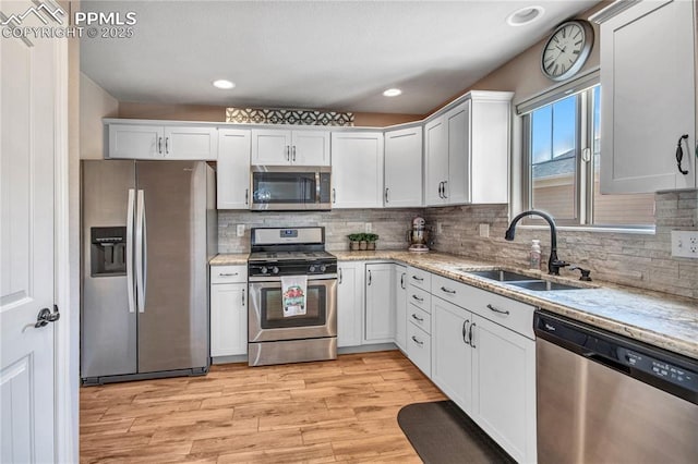 6728 Gelbvieh Rd, Peyton, CO 80831 - kitchen featuring stainless steel appliances, light wood-style floors, tasteful backsplash, light stone countertops, and recessed lighting