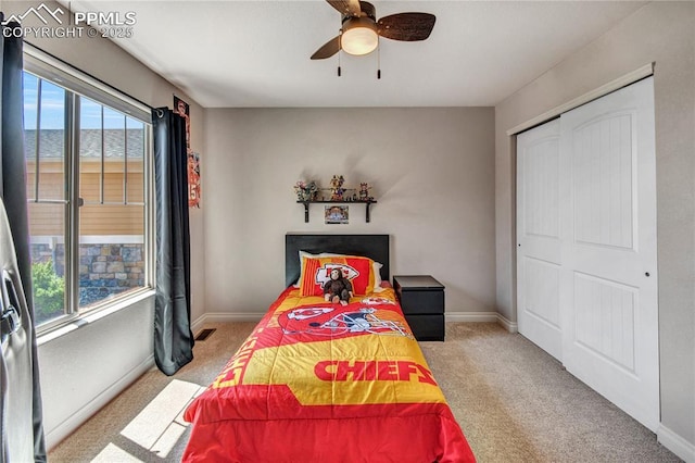 6728 Gelbvieh Rd, Peyton, CO 80831 - bedroom featuring multiple windows, light colored carpet, a ceiling fan, and a closet
