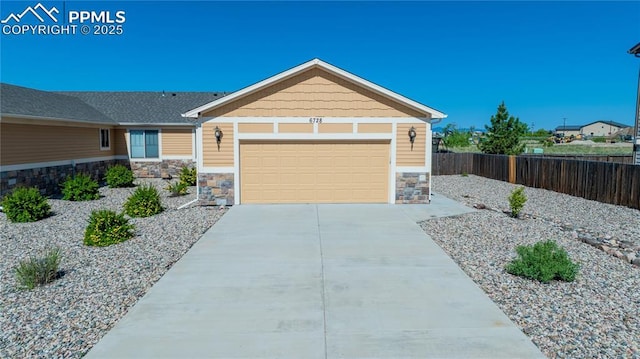 6728 Gelbvieh Rd, Peyton, CO 80831 - view of front of house featuring stone siding, a garage, and driveway