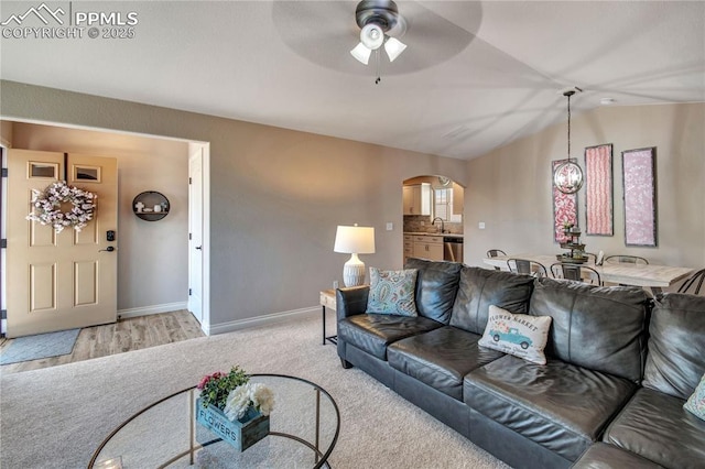 6728 Gelbvieh Rd, Peyton, CO 80831 - living area featuring arched walkways, ceiling fan, carpet, and lofted ceiling