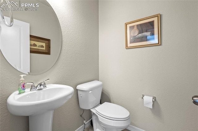 8442 Noreen Falls Dr, Colorado Springs, CO 80924 - half bathroom featuring toilet and baseboards