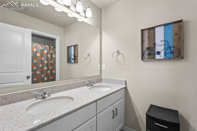 8442 Noreen Falls Dr, Colorado Springs, CO 80924 - full bathroom featuring double vanity and a textured wall