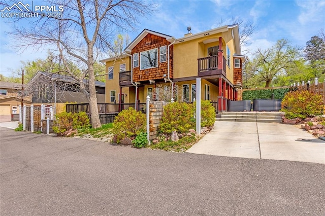 321 Graceland Grv, Colorado Springs, CO 80904 - townhome / multi-family property featuring a balcony, stucco siding, and concrete driveway