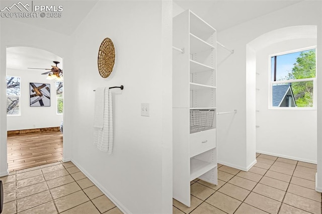 321 Graceland Grv, Colorado Springs, CO 80904 - walk in closet with light tile patterned floors, ceiling fan, and arched walkways