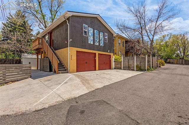 321 Graceland Grv, Colorado Springs, CO 80904 - view of front facade with a garage, stairs, and driveway