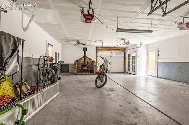 321 Graceland Grv, Colorado Springs, CO 80904 - garage with french doors, a garage door opener, electric panel, and a wood stove