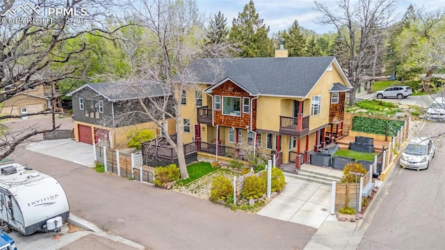 321 Graceland Grv, Colorado Springs, CO 80904 - view of front of property with a chimney, a balcony, driveway, and roof with shingles