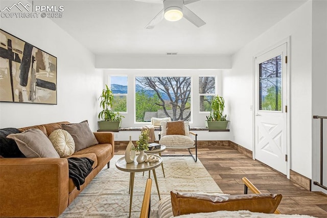 321 Graceland Grv, Colorado Springs, CO 80904 - living area featuring wood finished floors, healthy amount of natural light, a ceiling fan, and baseboards