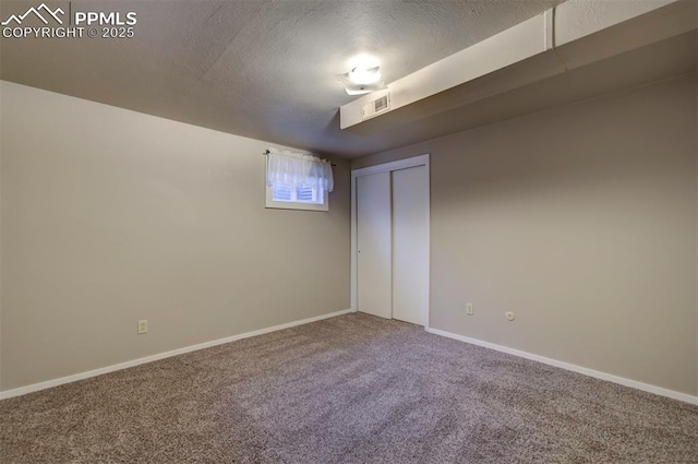 88 Watson Blvd, Colorado Springs, CO 80911 - unfurnished bedroom with carpet flooring, baseboards, a textured ceiling, and a closet