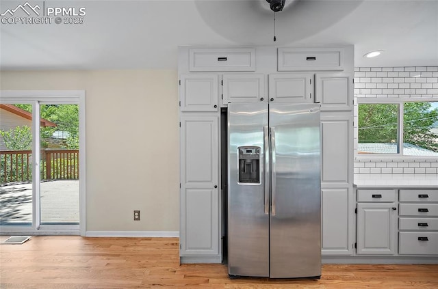 1515 W Boulder St, Colorado Springs, CO 80904 - kitchen with stainless steel refrigerator with ice dispenser, white cabinetry, light wood-style floors, light countertops, and recessed lighting