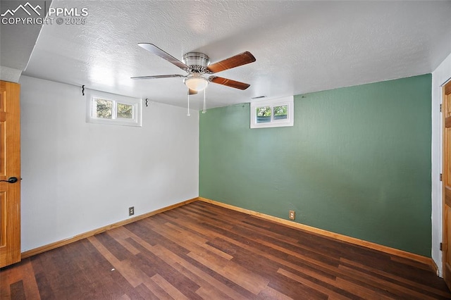 1515 W Boulder St, Colorado Springs, CO 80904 - empty room with dark wood-style flooring, plenty of natural light, baseboards, a ceiling fan, and a textured ceiling