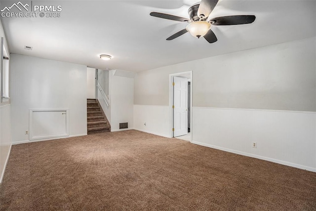 1125 Moffat Cir, Colorado Springs, CO 80915 - carpeted empty room with stairs, ceiling fan, and wainscoting