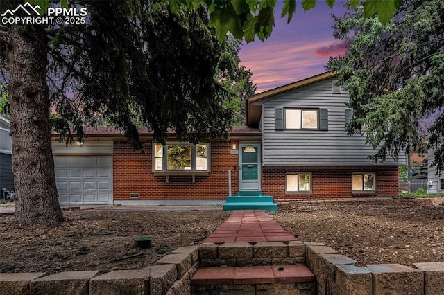1125 Moffat Cir, Colorado Springs, CO 80915 - split level home with brick siding and an attached garage
