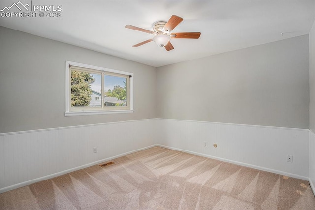 1125 Moffat Cir, Colorado Springs, CO 80915 - unfurnished room featuring ceiling fan, wainscoting, carpet flooring, and baseboards